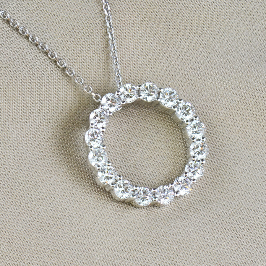 Round brilliant cut diamond and white gold circle pendant