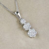 round cut diamonds and white gold cluster pendant