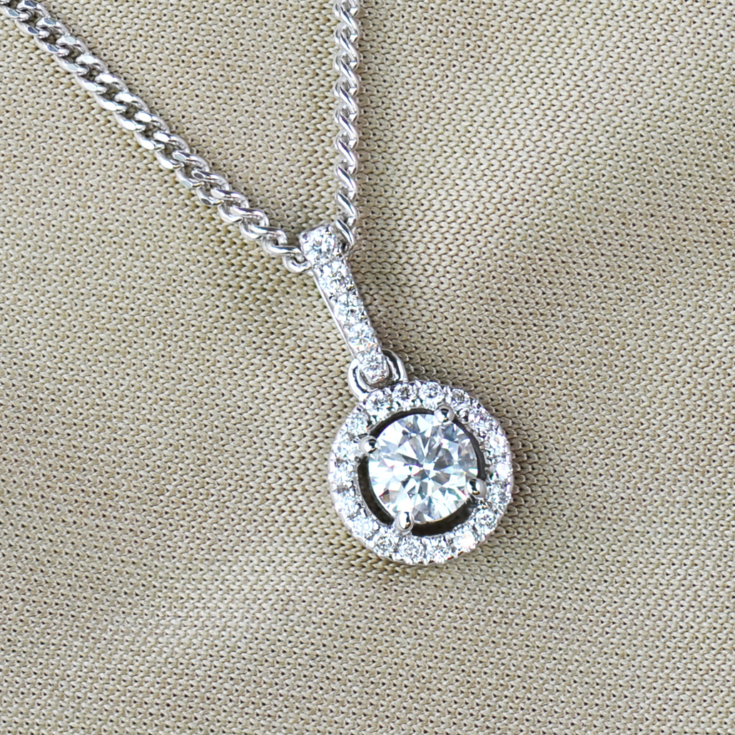 Round brilliant cut diamond halo pendant and chain